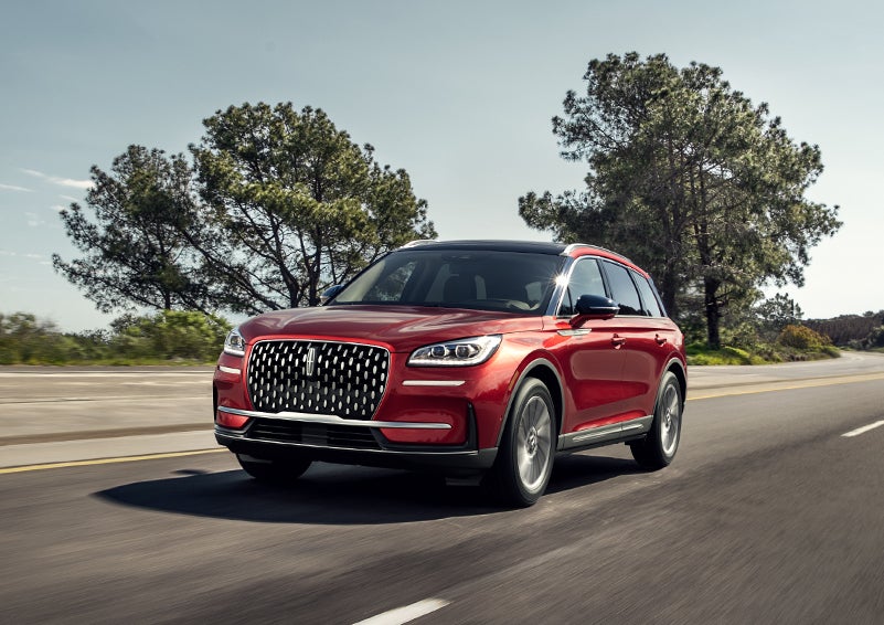 A 2024 Lincoln Corsair® SUV is shown being driven on a country road. | Gettel Lincoln in Punta Gorda FL