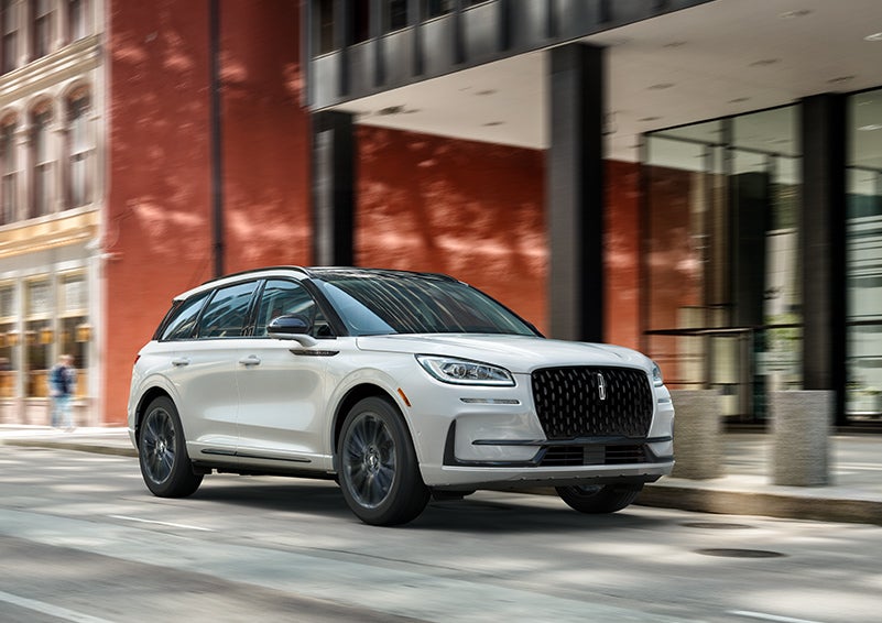 The 2024 Lincoln Corsair® SUV with the Jet Appearance Package and a Pristine White exterior is parked on a city street. | Gettel Lincoln in Punta Gorda FL