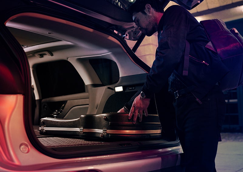 A man is shown loading cargo into the rear of a 2024 Lincoln Corsair® SUV with the second-row seats folded flat. | Gettel Lincoln in Punta Gorda FL