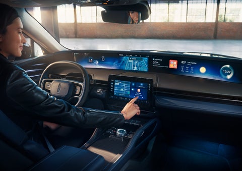 The driver of a 2024 Lincoln Nautilus® SUV interacts with the center touchscreen. | Gettel Lincoln in Punta Gorda FL