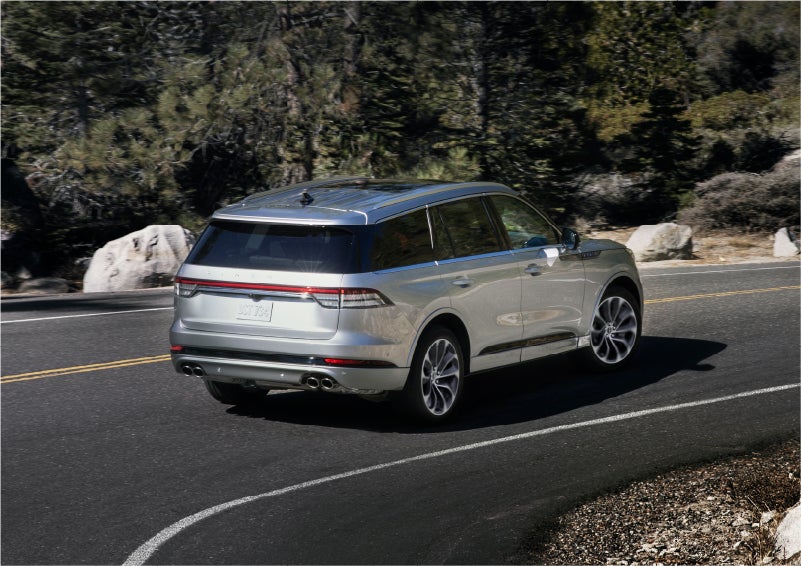 A 2023 Lincoln Aviator® Grand Touring model is shown being driven on a tight turn of a mountain road | Gettel Lincoln in Punta Gorda FL