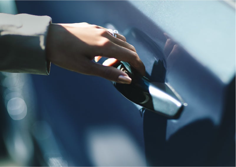 A hand gracefully grips the Light Touch Handle of a 2023 Lincoln Aviator® SUV to demonstrate its ease of use | Gettel Lincoln in Punta Gorda FL
