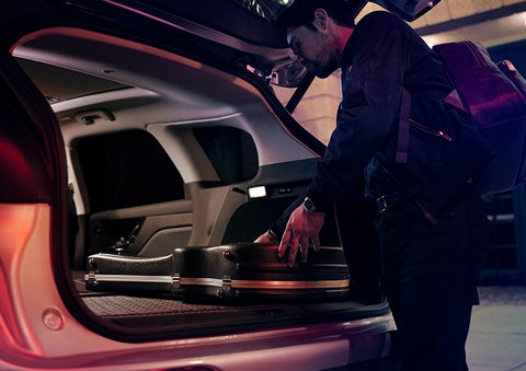 A man is shown loading cargo into the rear of a 2023 Lincoln Corsair® SUV with the second-row seats folded flat. | Gettel Lincoln in Punta Gorda FL