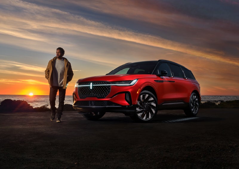 A person is shown next to a 2024 Lincoln Nautilus® SUV as the Lincoln Embrace sequence takes place. | Gettel Lincoln in Punta Gorda FL