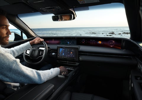A driver of a parked 2024 Lincoln Nautilus® SUV takes a relaxing moment at a seaside overlook while inside his Nautilus. | Gettel Lincoln in Punta Gorda FL